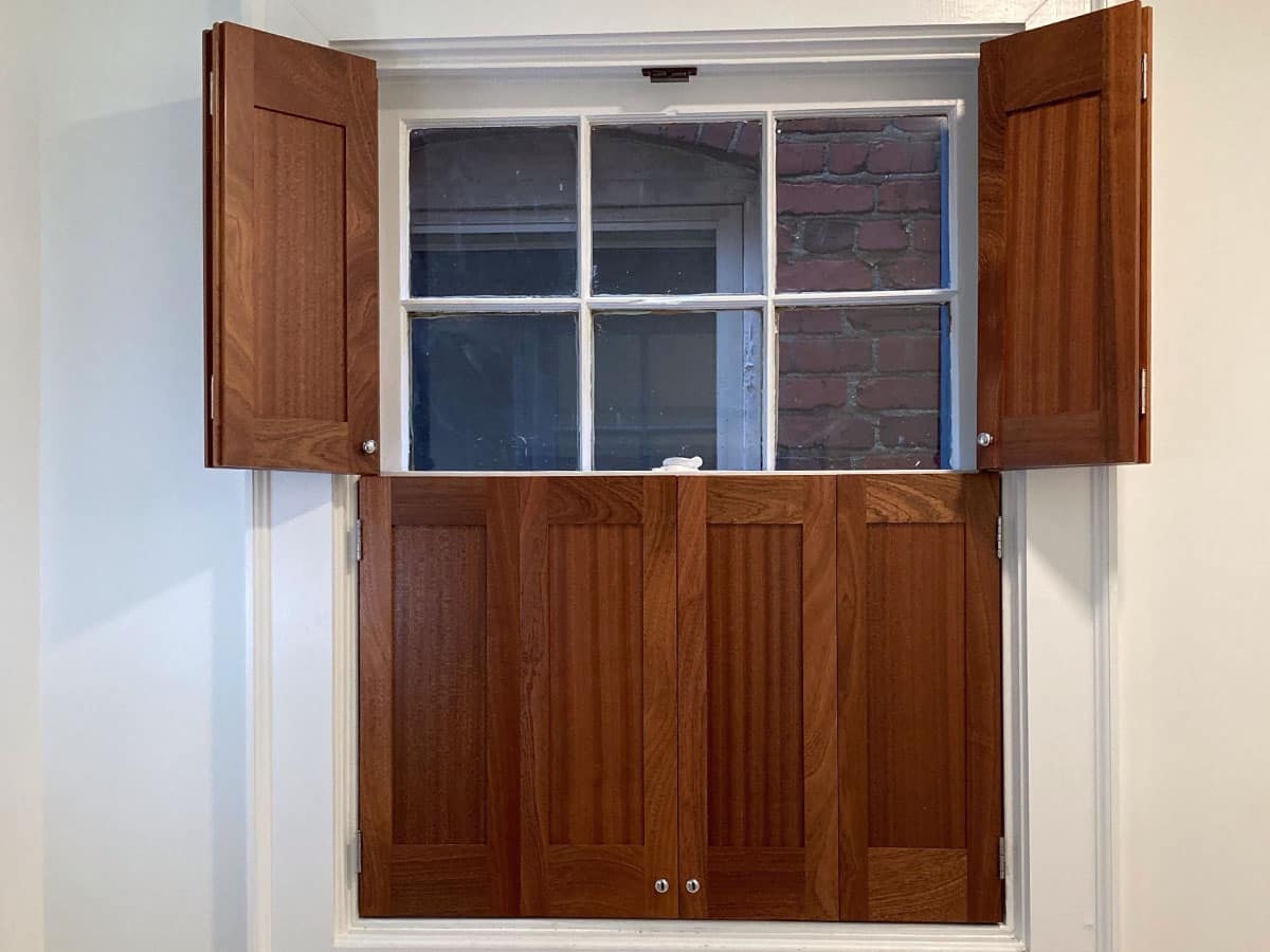 Installed Flat Panel shutters with top tier open Americana DeVenco Shutters